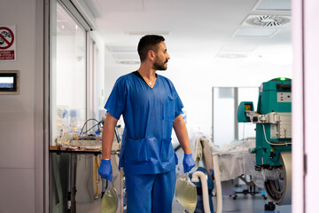 Nurse carrying medical waste in hospital corridor