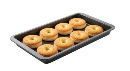 Freshly baked donuts arranged in a rectangular baking tray  
