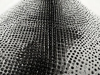 Abstract Perforated Metal Sheet Design A Modern Industrial Texture for Backgrounds and Creative Visuals on a Light Backdrop