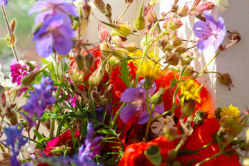 A vibrant bouquet of wild flowers brings joy and freshness. Sunlight highlights the delicate petals...