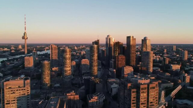 Aerial sunset view of Torontos downtown skyscrapers under construction, perfect for urban development websites, construction companies, and cityscape presentations. Suitable for commercial use.
