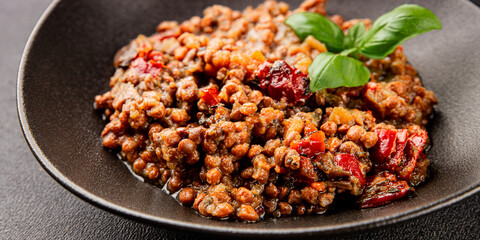 Lentil dish vegetables and roasted peppers savory vegetable fresh vegetarian and vegan food gourmet food background on the table rustic food top view copy space keto and paleo diet