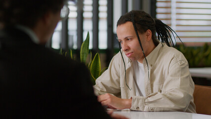 Two diversity business multiracial men businessmen in office talking papers documents research...