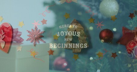 Showcasing lettering HERE'S TO JOYOUS NEW BEGINNINGS in shop window, with stars and tree silhouette
