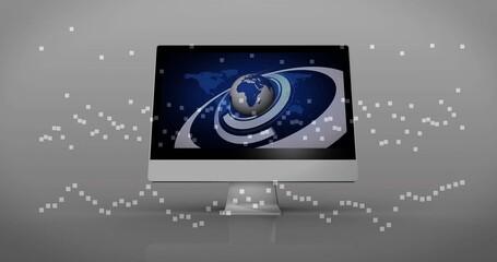 Displaying all-in-one computer showing 3D globe graphic on tabletop in studio, with pixel motifs