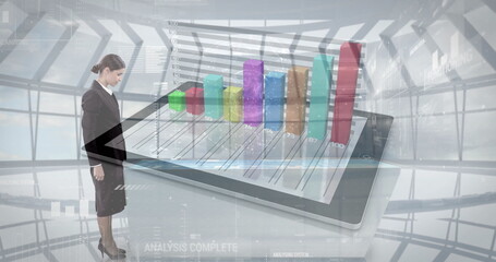 Standing businesswoman observing tablet displaying 3D bar chart in modern atrium, copy space