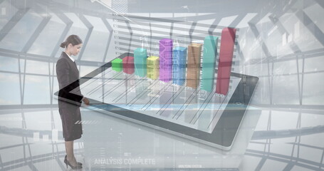Businesswoman in suit manipulating 3D bar chart using tablet in futuristic atrium, copy space