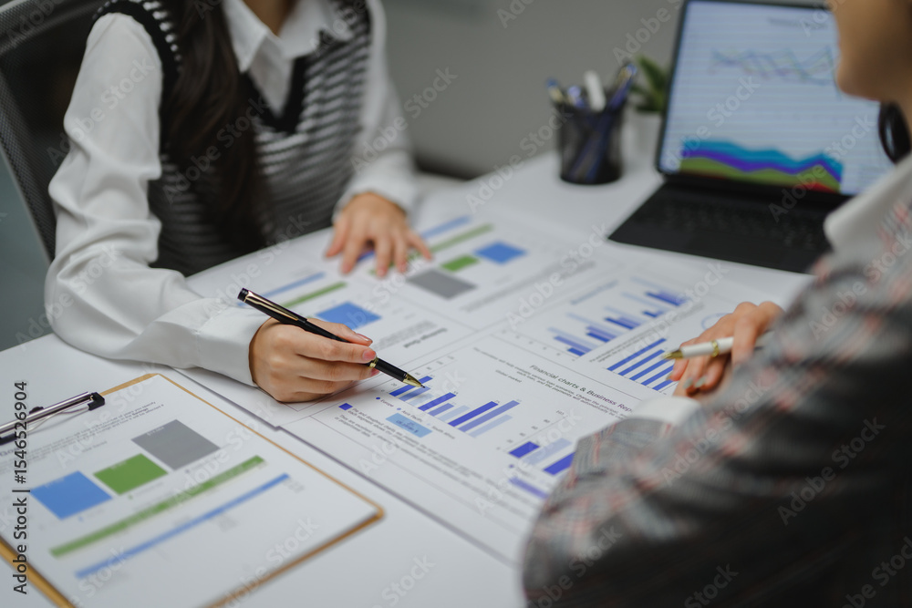 Poster business team analyzing financial charts and business reports using pens and digital tablet during a