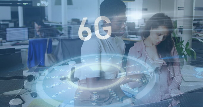 Two professional women examining smartphone and coffee cup in open-plan office, with 6G graphic