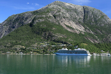 Landscape photo with a view of the mountains, big cruise liner and Hardanger Fjord near the city of...