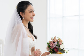 Asian Beautiful bride smiling holding bouquet flowers wedding dress veil elegant jewelry bright...