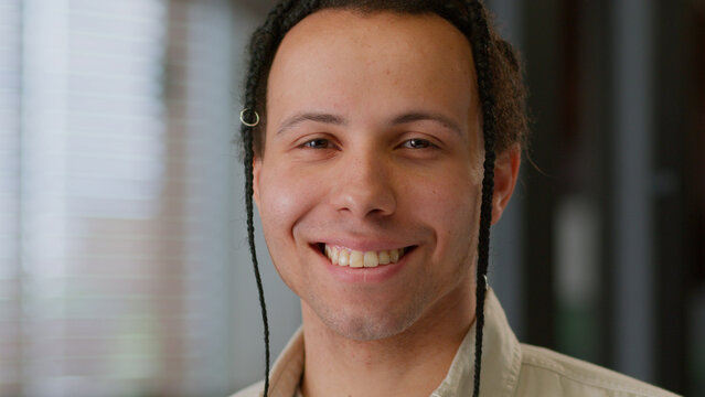 Close up headshot male ethnic businessman smiling face portrait business man American guy professional with dreadlocks braids looking at camera smile in office company working startup manager indoors - Powered by Adobe