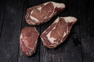 Wagyu steak on a rustic wooden background, top view, copyright