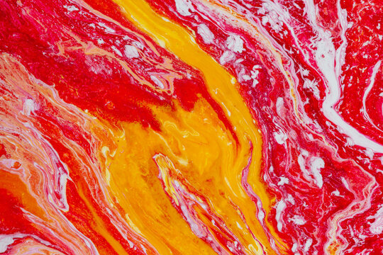 Vibrant red and yellow abstract acrylic fluid art texture, swirling marble pattern background