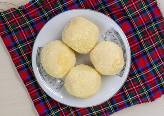 Top view of tasty Bengali Kachagolla sweets on ceramic plate. Popular for soft, spongy texture and subtle sweetness.