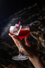 Female hand holding a red cocktail