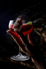 Female hand holding a red cocktail