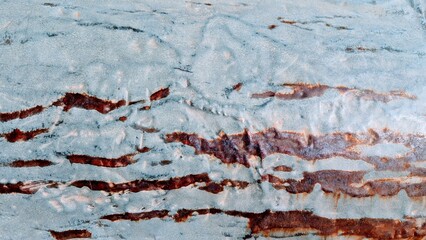 Textured dented metal surface with abstract rust patterns and natural color variations for artistic expression