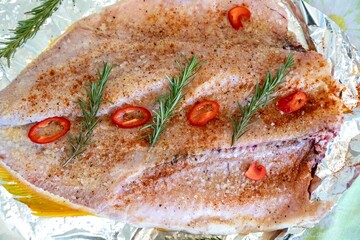 Traditional Brazilian golden tropical fish Salminus brasiliensis roasted with traditional seasonings, plantain, potatoes and rosemary. Dourado assado
