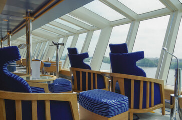 Luxurious modern observation or panorama lounge with floor to ceiling windows onboard expedition...