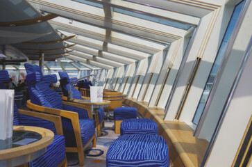 Luxurious modern observation or panorama lounge with floor to ceiling windows onboard expedition...