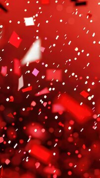 Colorful red confetti cascades through the air, creating a festive and lively environment, perfect for celebrations.
