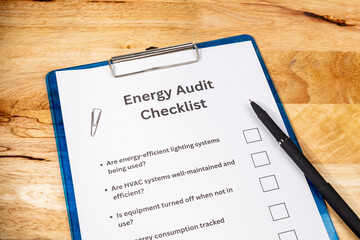 Energy Audit Checklist Document with Pen on Wooden Desk – Efficiency and Utility Review Concept