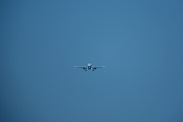 Airplane in the blue sky. The plane is ready for landing