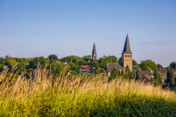 the two churches called Wiesnasen of Ratingen Homberg at summer evenig sun with blue sky 