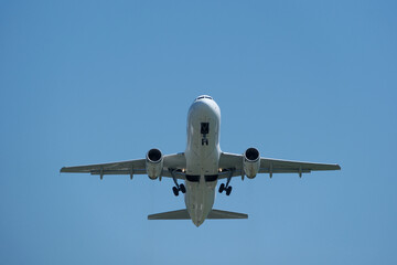 Airplane in the blue sky. Airplane taking off against blue sky