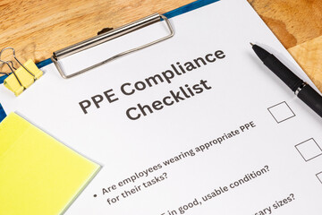 PPE Compliance Checklist Document with Pen on Desk – Workplace Safety and Equipment Regulation...