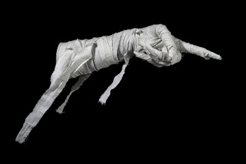 Mummy's hand wrapped in a bandage creepily pointing on isolated background. The hand of the mummy monster for Halloween horror concept