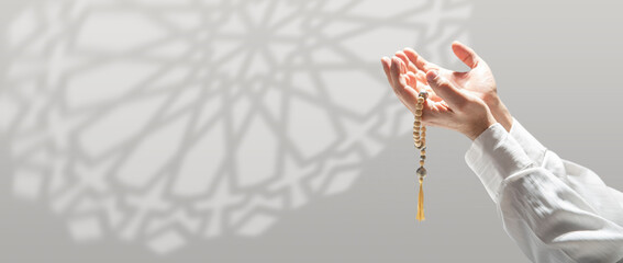 Prayer Salah or Namaz. Praying Hands with wooden rosary. Concept of Muslim religion.