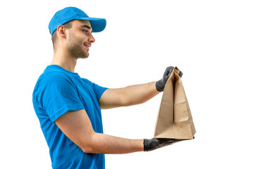 Delivery man with paper bag. Courier in uniform cap and t-shirt, gloves service fast delivering orders. Young guy holding a cardboard package. Character on isolated white background for mockup design