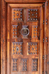 Old wooden door with wrought iron details in Villanueva de los Infantes town