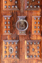 Old wooden door with wrought iron details in Villanueva de los Infantes town