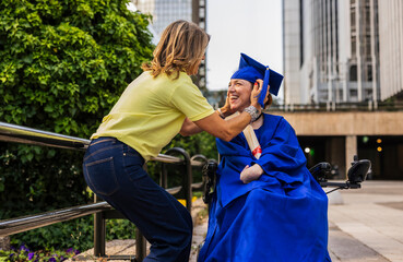 Proud mother adjusting graduation cap of disabled daughter in wheelchair