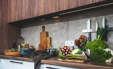 Fresh vegetables and herbs on a countertop ready for healthy cooking in a modern kitchen