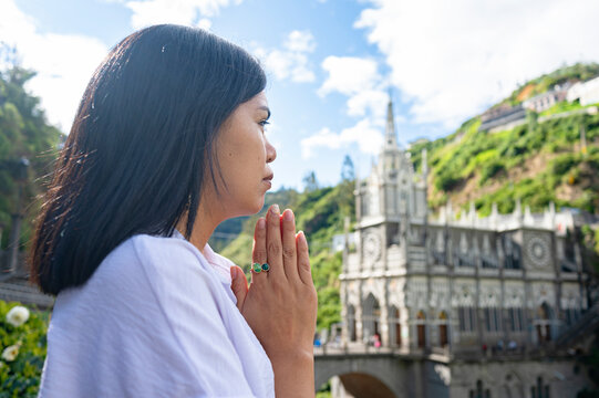 Woman praying in front of the church in Las Lajas, southern Colombia