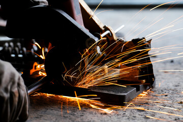 cutting a steel plate with an electric cutting wheel at a factory