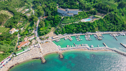 Italy, June 22, 2025: aerial view from the drone of the Vallugola Bay with its tourist port immersed in the San Bartolo park near Pesaro and the Romagna coast