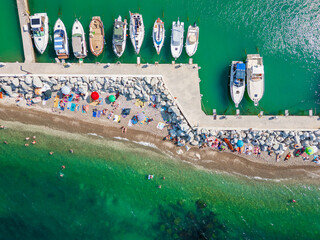 Italy, June 22, 2025: aerial view from the drone of the Vallugola Bay with its tourist port immersed in the San Bartolo park near Pesaro and the Romagna coast