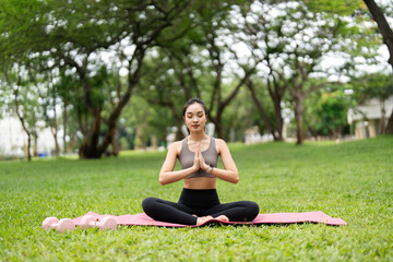 Yoga meditation outdoors. Young woman practicing mindfulness with hands in prayer position.
