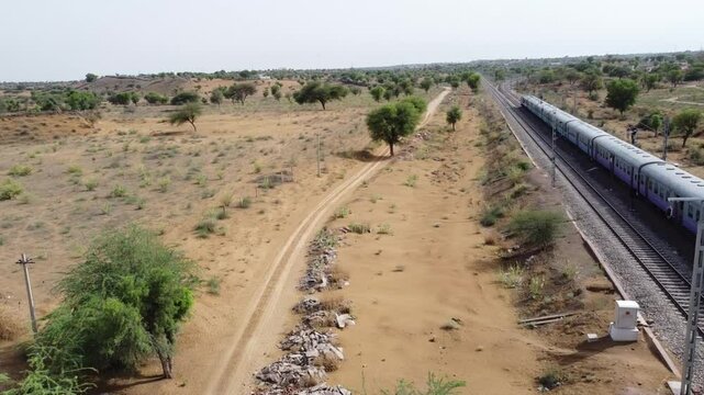 Aerial of Drone view of a running Train from left to right, in the Thar Desert of Rajasthan(India)