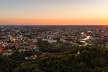 Scenic aerial view of Vilnius Old Town and Neris river at nightfall. Sunset landscape.