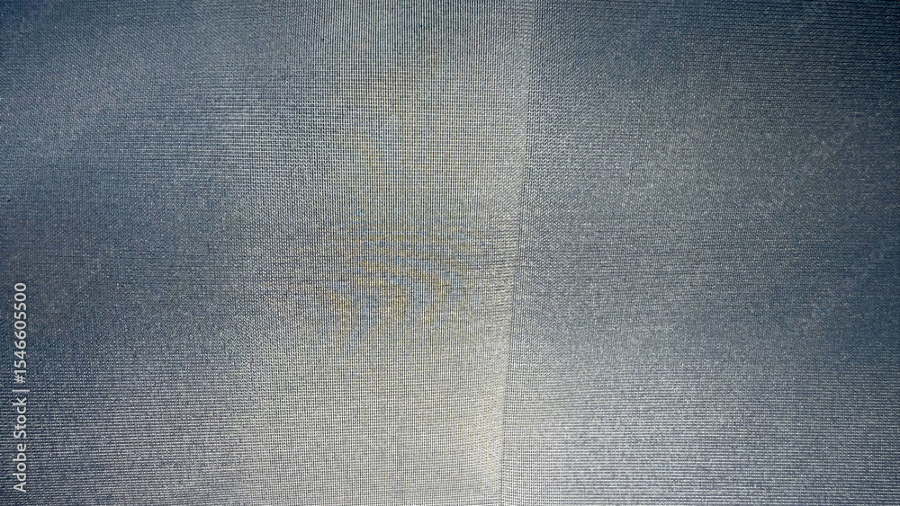 Poster close-up of silver gray textile with fine woven grid pattern and central seam, ideal for use in modern fabric texture background, branding, or packaging design

