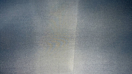 close-up of silver gray textile with fine woven grid pattern and central seam, ideal for use in...