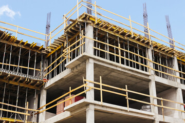 Concrete building under construction. Unfinished structure framework. Modern architecture site view. Reinforced skeleton in progress. Real estate development zone. New apartment block in progress.