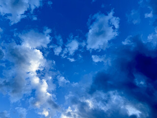 dramatic twilight sky with layered cumulus clouds and deep blue tones, ideal for website header,...