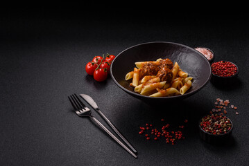 Penne pasta with meatballs in tomato sauce with salt and spices. Italian food penne pasta